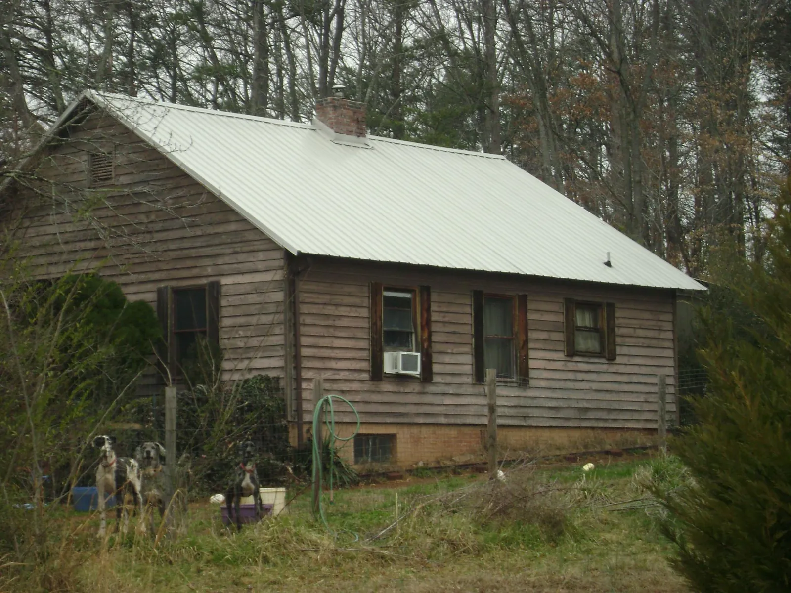White metal roof on an old wood sided farmhouse, from a Metal Roof Installation job in Camp Grove